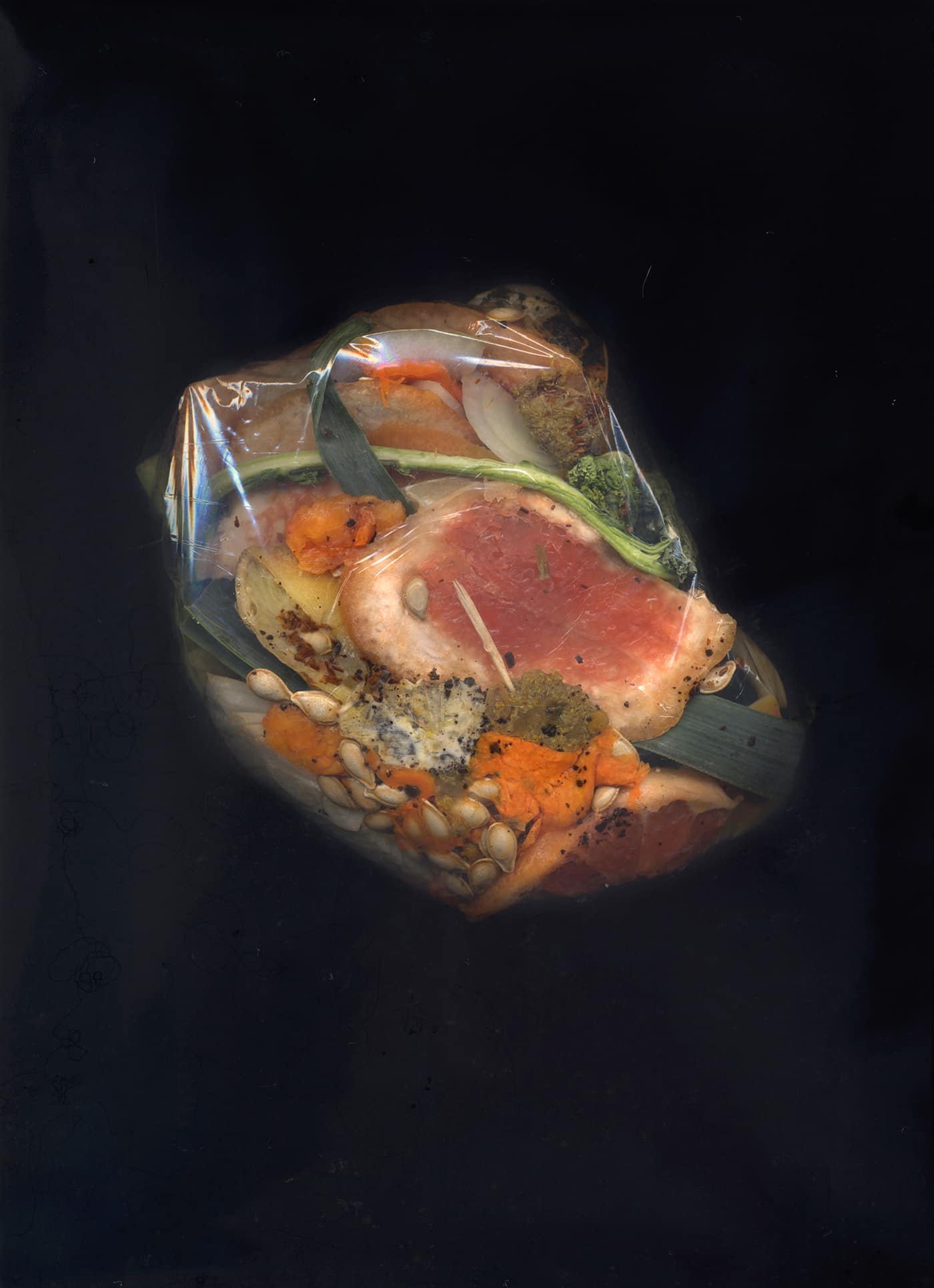 Photograph of a bag filled with compost on black background