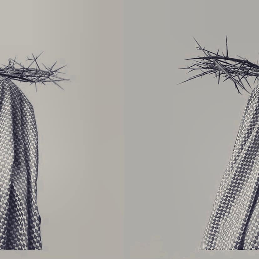 Palestinian woman is covered by a national scarf and carrying the weight of pain and thorns on her head